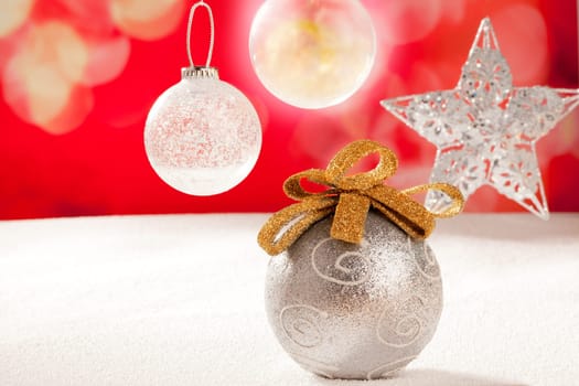 Christmas silver bauble and star on snow red background