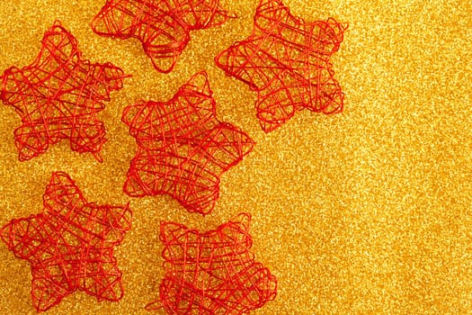 christmas golden stars of wire over golden glitter background