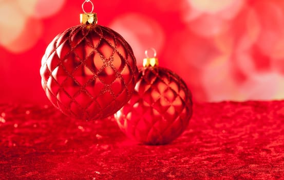 Christmas card of red capiton bauble on blurred background
