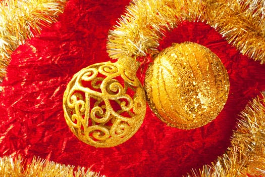 Christmas card golden bauble arabesque and tinsel on red background