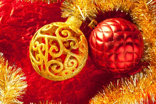 Christmas card golden bauble arabesque and tinsel on red background