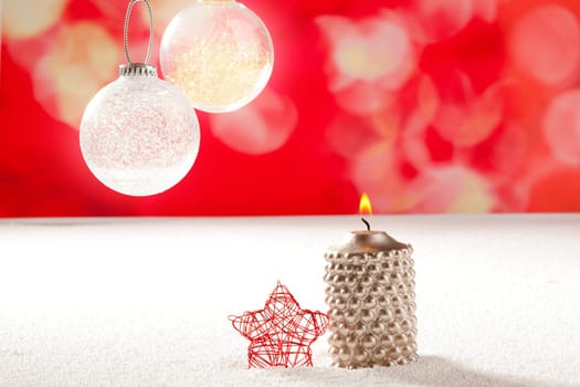 christmas silver candle and red star on snow and red with glass baubles