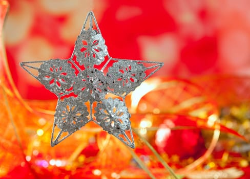 Christmas card of silver star and red blur background