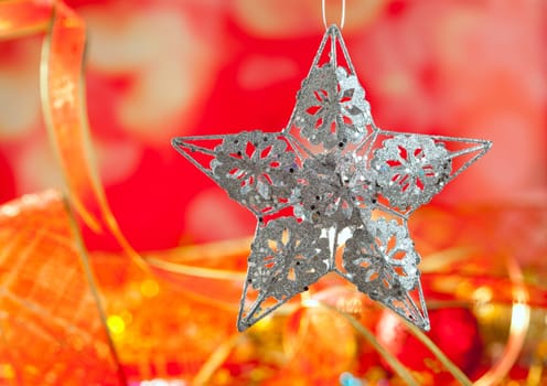 Christmas card of silver star and red blur background