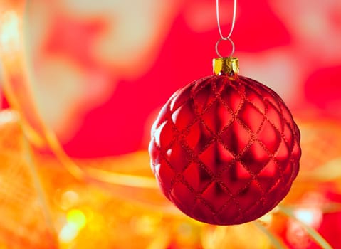 Christmas card of red capiton bauble on blur background