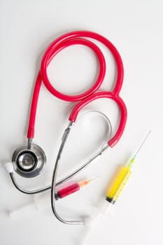 Medical equipment tools isolated on white, stethoscope and syringe