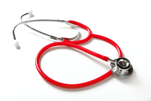 Medical still photo with red stethoscope over white background
