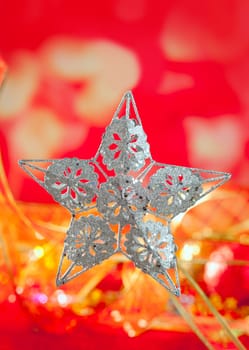 Christmas card of silver star and red blur background