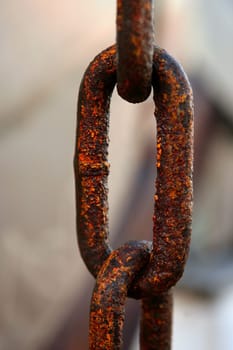 Macro chain link, rusted steel. Marine environment