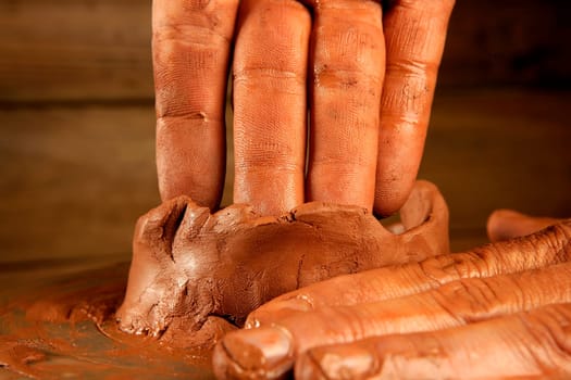 pottery craftmanship red clay potter hands work finger closeup