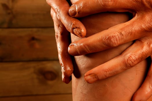 pottery craftmanship red clay potter hands work finger closeup