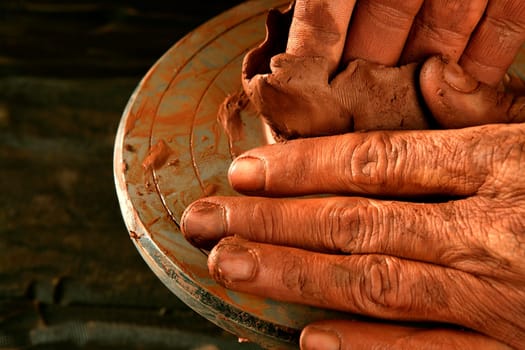 pottery craftmanship red clay potter hands work finger closeup