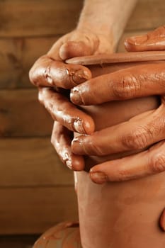 pottery craftmanship red clay potter hands work finger closeup