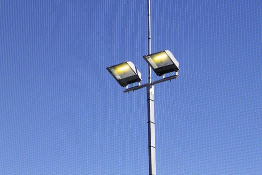 sport field lighting equipment spots  light blue sky
