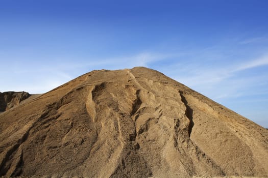 brown construction sand quarry mountain blue sky