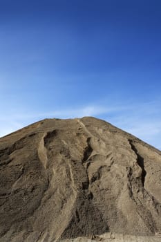 brown construction sand quarry mountain blue sky