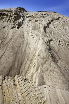 white sand quarry mound like moon mountain blue sky