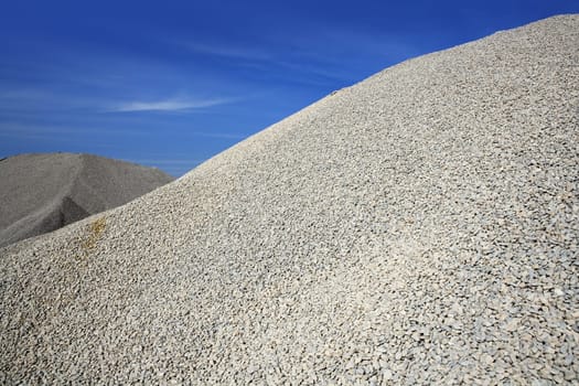 gravel gray mound quarry stock blue sky rolling stones