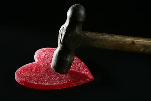 Breaking the love or the health, hammer beating a red heart
