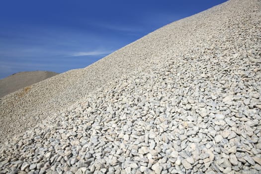 gravel gray mound quarry stock blue sky rolling stones