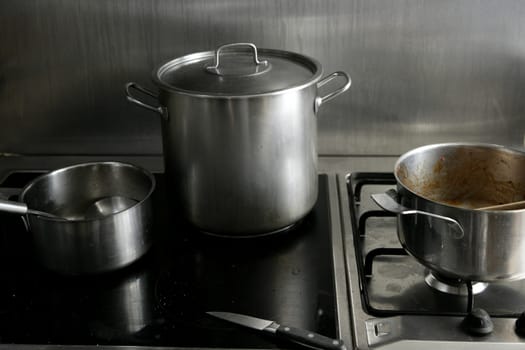Dirty used stainless steel kitchen cooking stuff, pans