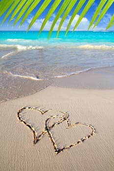 hearts in love written in Caribbean beach sand tropical aqua sea