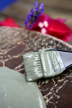 Mud, green clay natural therapy for skin mask and flowers: bougainvillaea, lavender