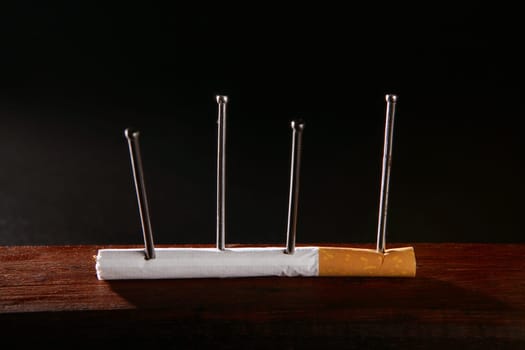 Nicotine tobacco addiction concept metaphor cigarette and nails