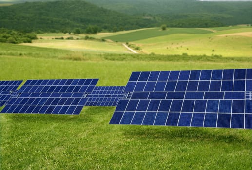 Clean electric energy solar plates generators in a green meadow