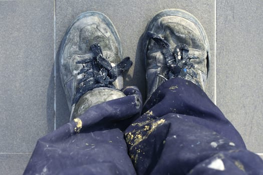 manual man worker old shoes detail high view dirty pants