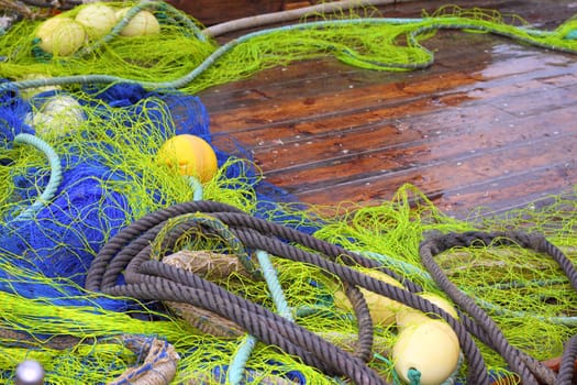 fishemen professional tackle net on boat wooden wet deck