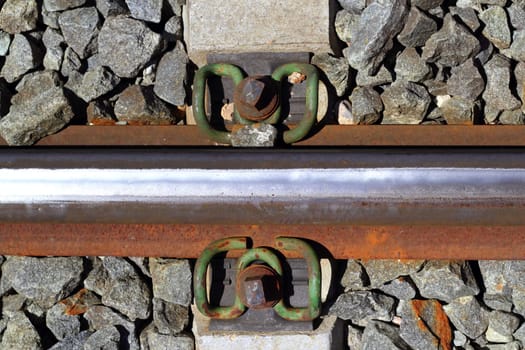 iron rusty train railway detail over dark stones rail way