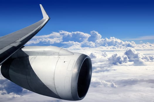 airplane wing aircraft turbine flying blue sky white clouds