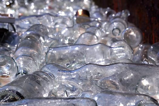 ecological recycling glass bottles in messy container