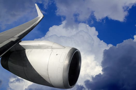 airplane wing aircraft turbine flying blue sky white clouds