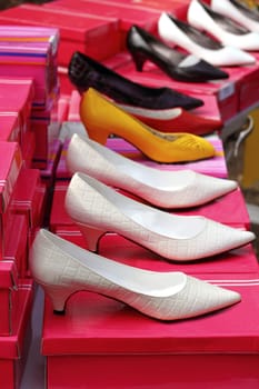 fashion woman heel shoes shop in a row over pink boxes
