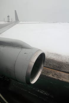 aircraft wing with turbine landing on winter snow runway