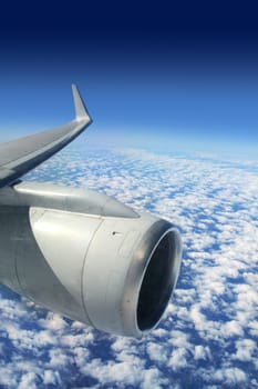 airplane wing aircraft turbine flying blue sky white clouds