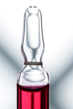 Glass ampoule with red liquid medicine inside