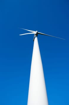 aerogenerator windmill in blue sky perspective background