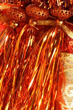Golden christmas macro decoration, red background, studio shot