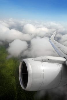 airplane wing aircraft turbine flying jungle bottom white clouds