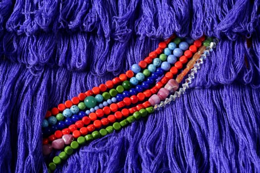 Color stones jewelry necklaces, blue fabric background
