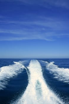 Fishing speedy boat prop wash, white wake on the blue ocean sea