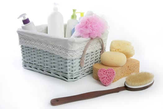 Bath toiletries basket with shower gel shampoo sponge and towel
