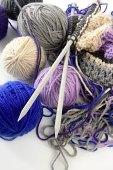 colorful knitting tools with wool thread balls