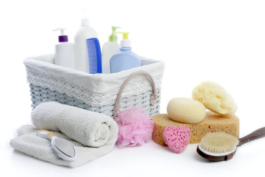 Bath toiletries basket with shower gel shampoo sponge and towel