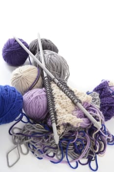 colorful knitting tools with wool thread balls