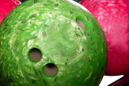 Bowling balls red green closeup row detail