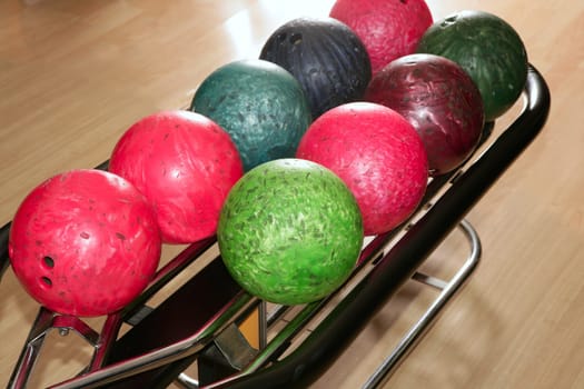 Bowling balls red green closeup row detail